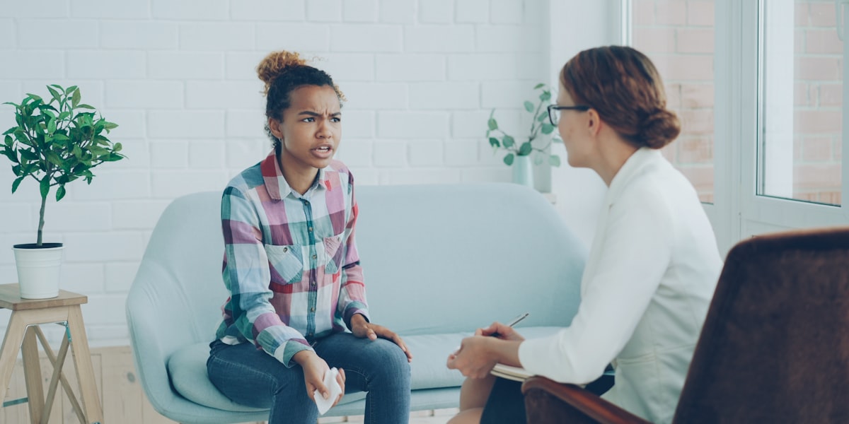 Therapist writing clinical notes after a patient session